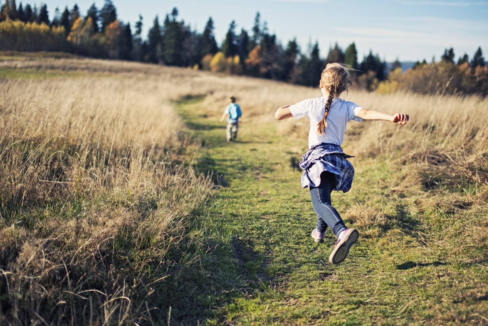 Kids skipping through a field