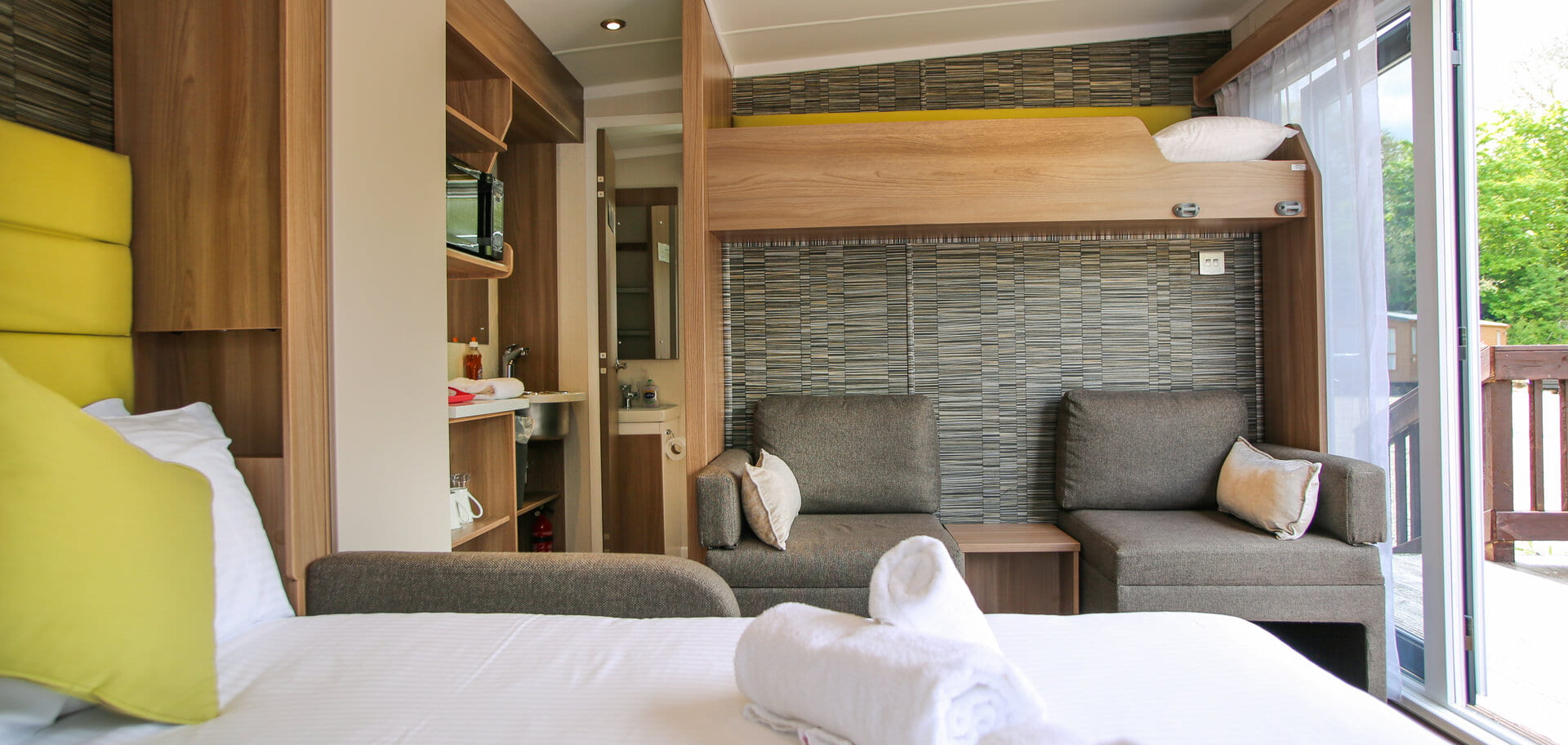 Interior of 4 berth glamping pod- bunk bed and chairs
