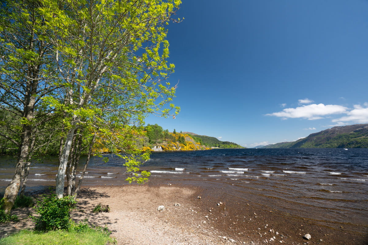 View from a beach looking down Loch Ness